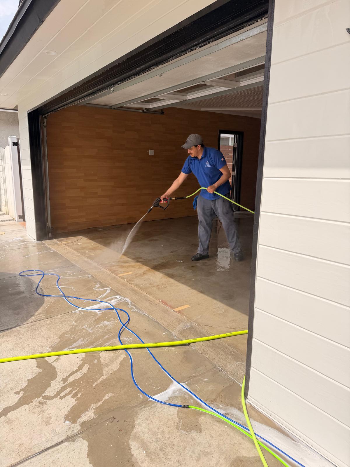 SL Prime uniformed professional pressure washing a residential garage