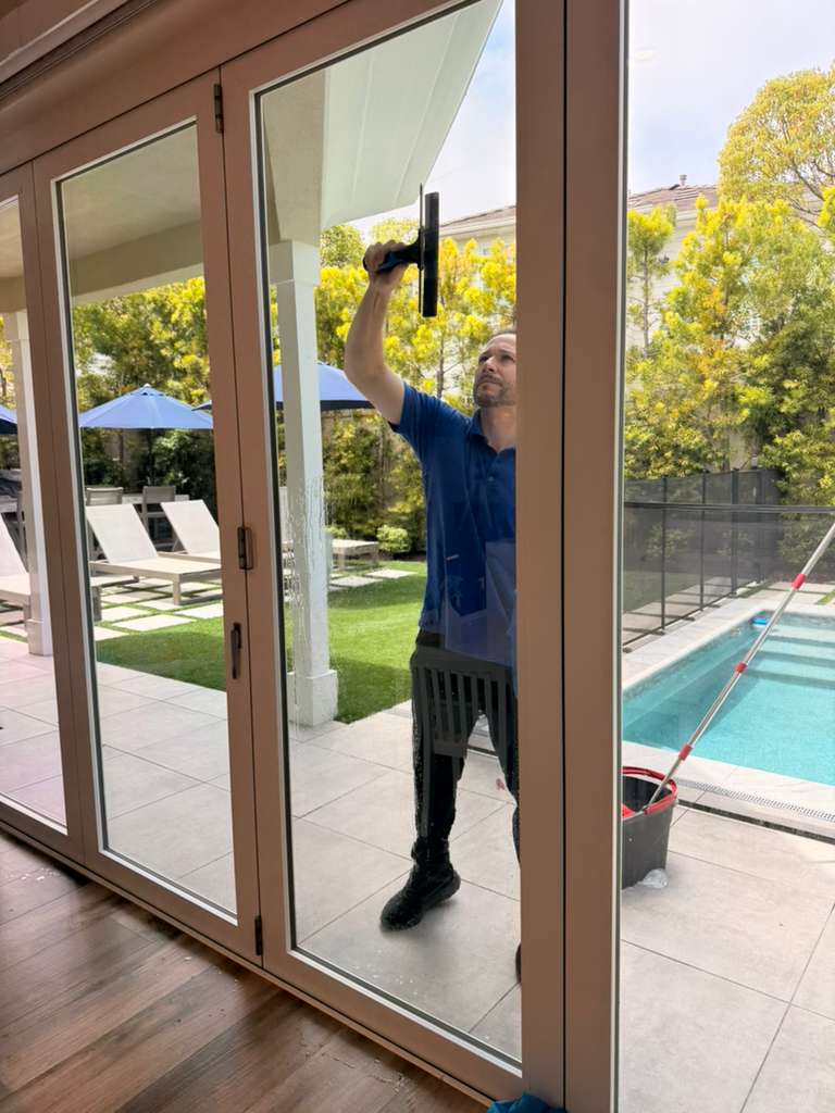 Jeremy providing professional window cleaning at an Orange County home